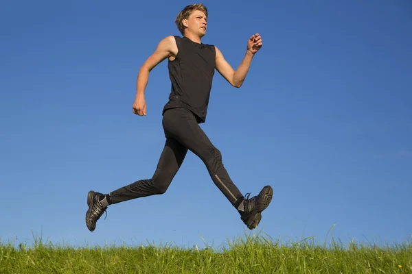 Sportsman is run on top of hill — Stock Photo, Image
