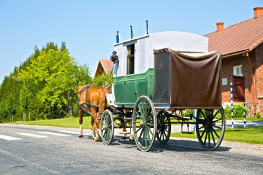 Wagon on road is moving by horses clipart