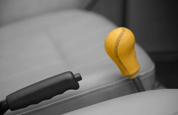 Shaded bigger machine yellow transmission between seats — Stock Photo, Image