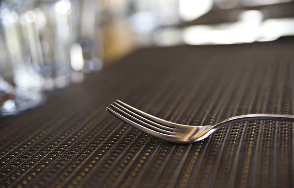 Lonely chromed fork on kitche table — Stock Photo, Image