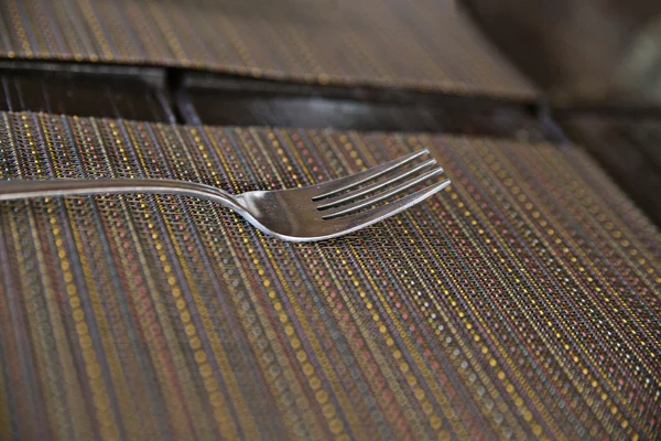 One chromed fork on kitche table — Stock Photo, Image
