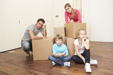 Young family looking upset among boxes clipart