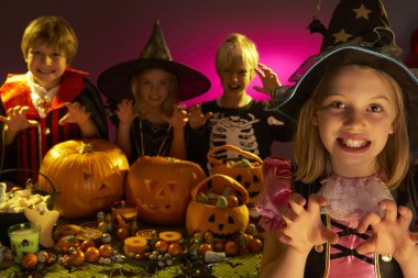 Halloween party with children wearing scaring costumes clipart