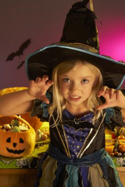 Halloween party with a child wearing scaring costume clipart