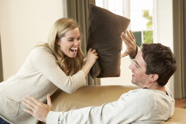 Eğlenceli olan genç bir çift kanepede gülüyor — Stok fotoğraf