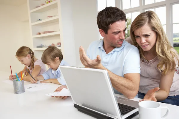 Young couple thinking and looking at a laptop computer — Stock Photo, Image