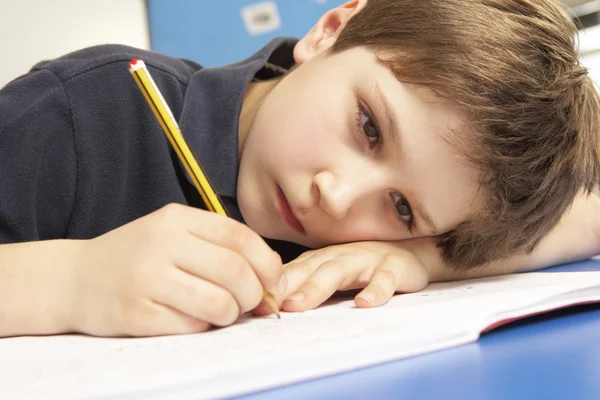 Unhappy Schoolboy Studying In Classroom — Stock Photo, Image