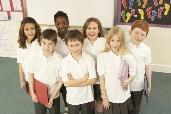 Retrato de crianças em idade escolar em pé na sala de aula — Fotografia de Stock