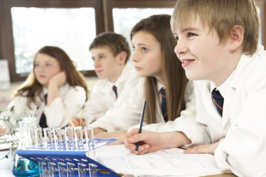 Group Of Teenage Students In Science Class clipart