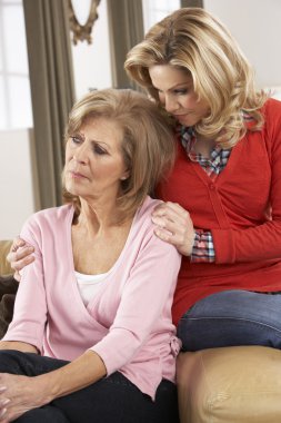 Senior Woman Being Consoled By Adult Daughter clipart