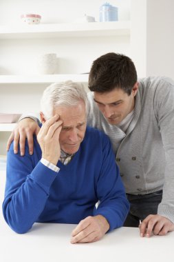 Grown Up Son Consoling Senior Parent clipart