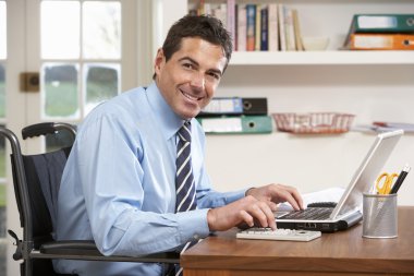 Man Working From Home Using Laptop clipart