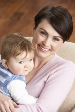 Portrait Of Mother With Baby At Home clipart