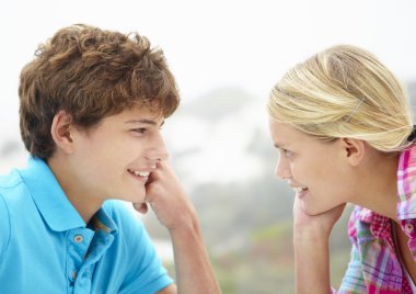 Teenage girl and boy head and shoulders in profile clipart