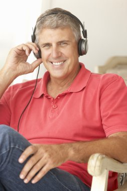 Mid age man wearing headphones clipart