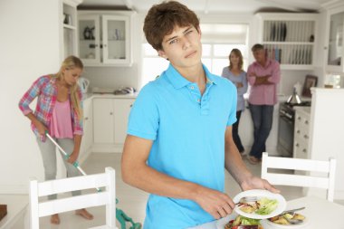 Teenagers reluctantly doing housework clipart