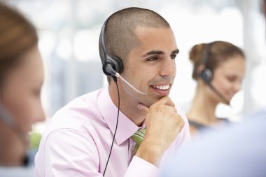 Young businessman wearing headset clipart