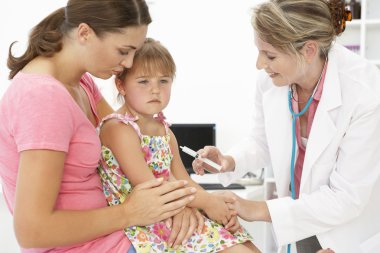 Female doctor injecting child clipart