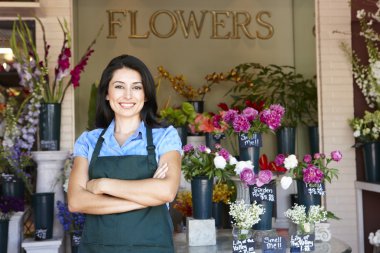 Woman standing outside florist clipart