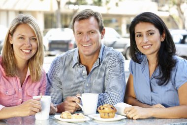 Friends chatting outside café clipart