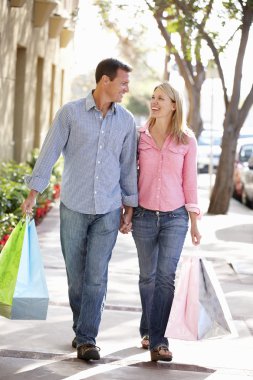 Couple carrying shopping clipart