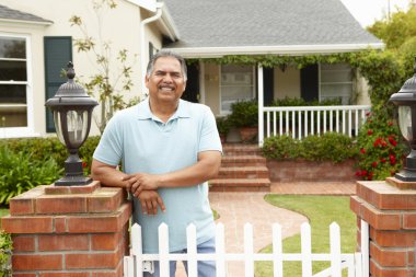 Senior Hispanic man outside home clipart