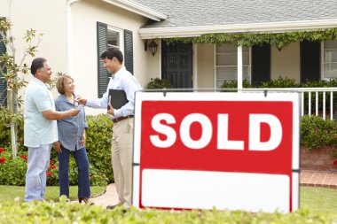 Senior Hispanic couple buying new home clipart