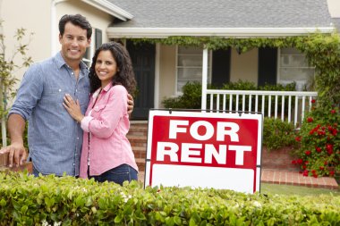 Hispanic couple outside home for rent clipart