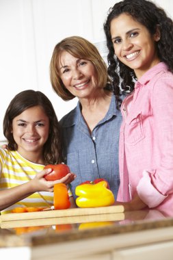 Mother,daughter and grandmother cooking clipart