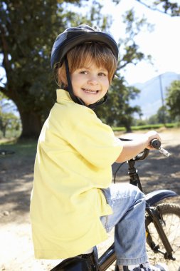 Little boy on country bike ride clipart