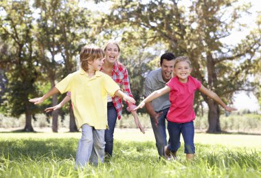 Parents playing with children in country clipart