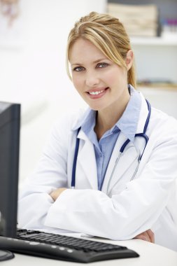 Young doctor at desk clipart