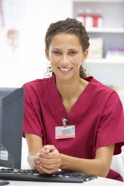 Young hospital doctor at desk clipart
