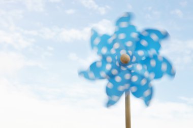 Child's plastic windmill turning in wind clipart