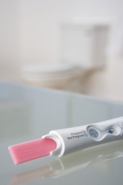 Pregnancy testing kit in bathroom clipart