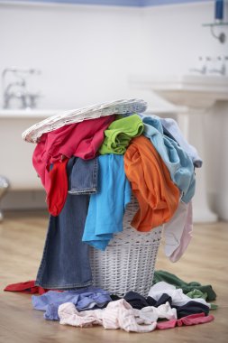 Pile of dirty washing in bathroom clipart