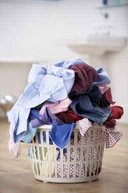 Basket of dirty washing in bathroom clipart