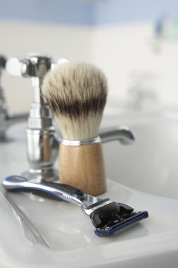 Man's shaving kit in bathroom clipart