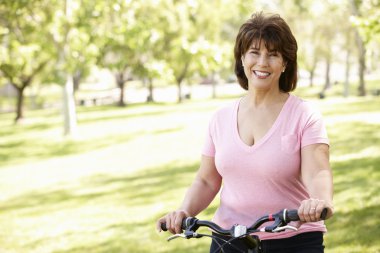 Senior Hispanic woman with bike clipart