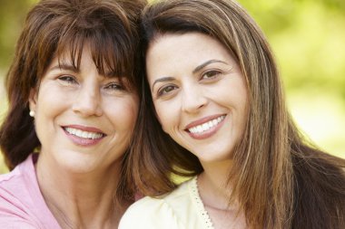 Portrait Hispanic mother and adult daughter clipart