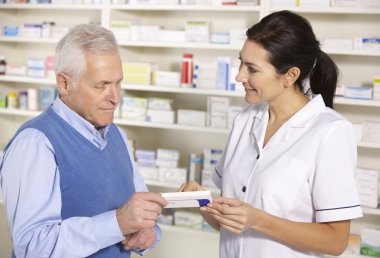 American pharmacist serving senior man in pharmacy clipart