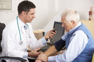 American doctor taking senior man's blood pressure clipart