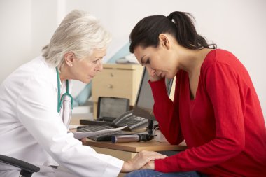 American doctor with depressed woman patient clipart