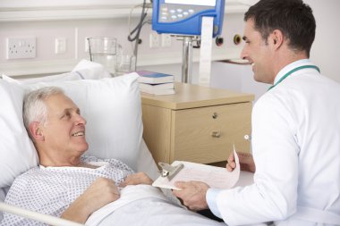 Doctor with senior male patient on USA Hospital ward clipart