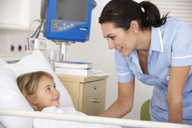 Nurse with child patient in UK Accident and Emergency clipart