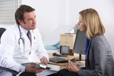 American doctor talking to businesswoman patient clipart