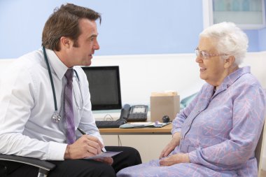 UK GP talking to senior woman patient clipart