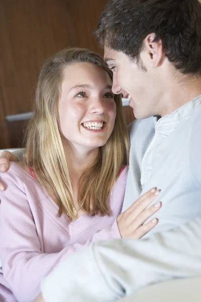 Romantic Teenage Couple Sitting On Sofa At Home Together — Stock Photo, Image