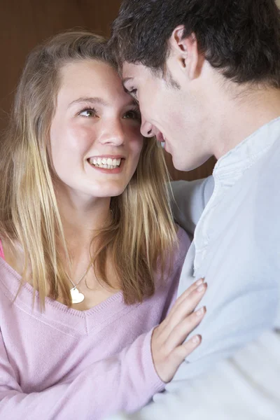 Romantic Teenage Couple Sitting On Sofa At Home Together — Stock Photo, Image