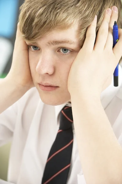 Gestresste männliche Teenager studieren im Klassenzimmer — Stockfoto